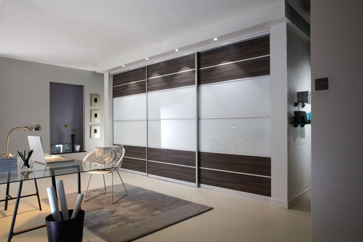 Modern study area with built in wardrobe with dark wooden & glass sliding doors